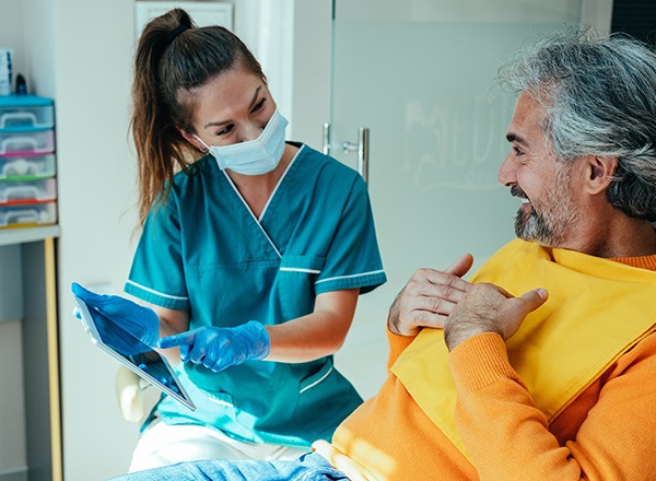 Patient in Queen Creek reviewing dental implant post-op instructions with dental team