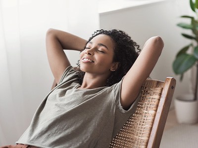 Patient in Queen Creek resting at home after dental implant surgery