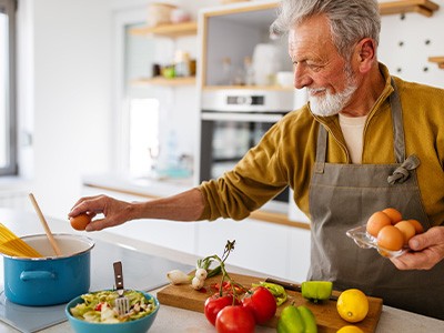 Patient preparing pasta after dental implant surgery in Queen Creek