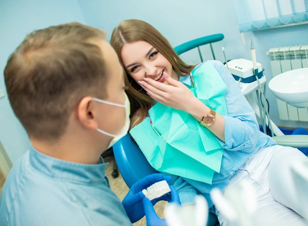 young woman smiling with her dentist 