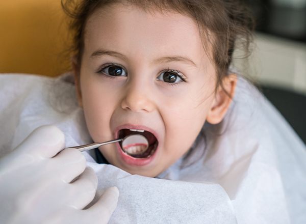 Little girl receiving dental exam