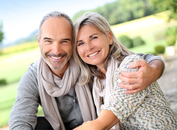 Older man and woman smiling outdoors