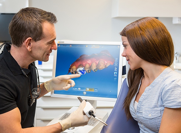 Dentist and patient looking at digital impressions