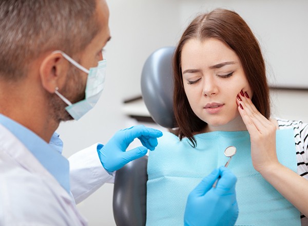 Man in blue shirt suffering from a toothache