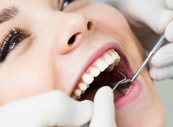 Woman receiving dental exam