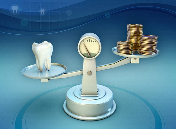 A scale holding a tooth on one end and money on the other