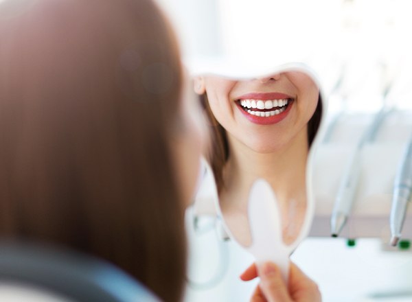 Woman looking at smile in mirror