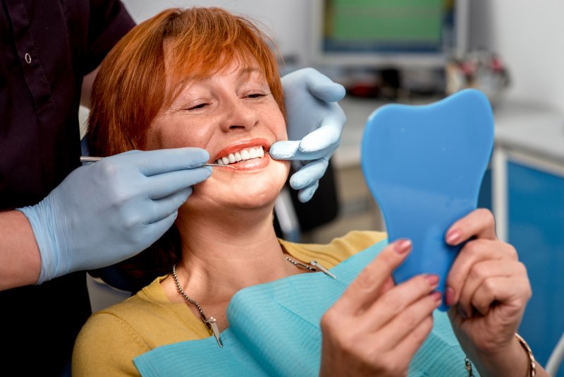 Woman showing off dental implants in Queen Creek
