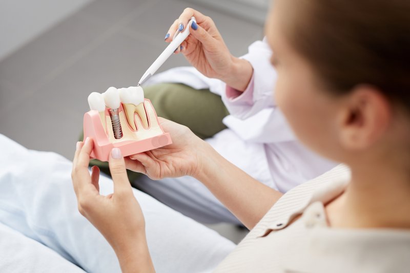 dentist explaining dental implant to patient