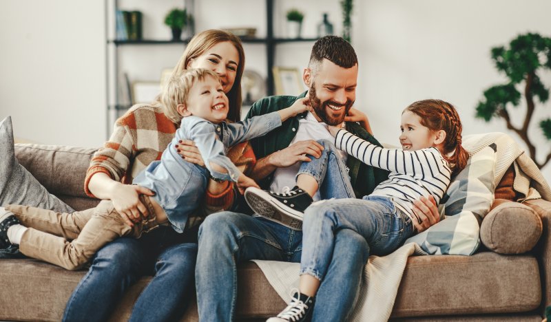 family laughing together on couch