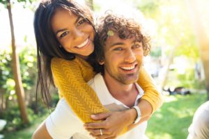 Couple with beautiful smiles in the sun thanks to Queen Creek dentist