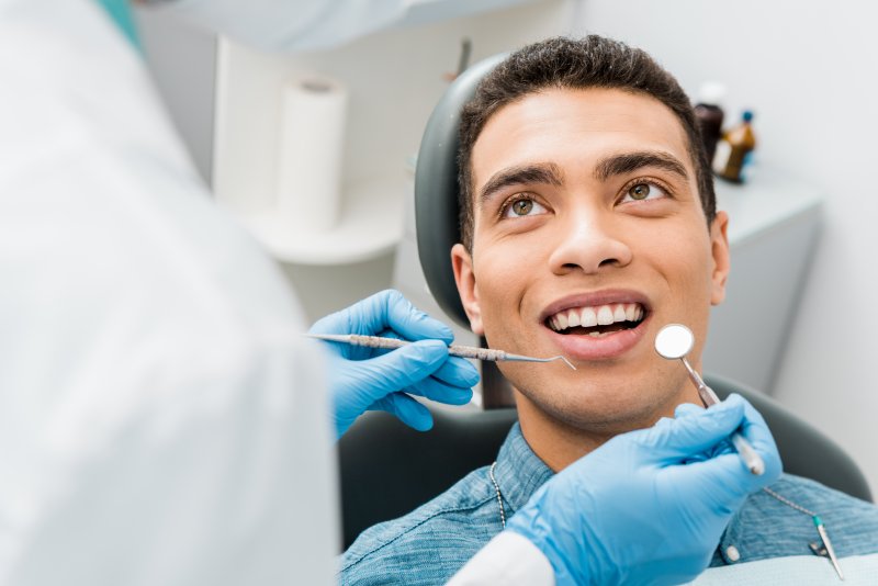 A patient receiving early detection of oral health problems