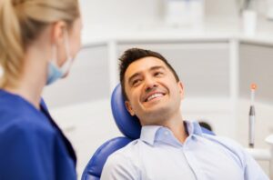 Man smiling while at the dentist for his oral thrush